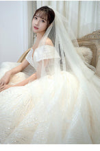 Load image into Gallery viewer, Shining Sequins Luxury Wedding Dress With Sweep Train Elegant Boat Neck Off The Shoulder Ball Gown
